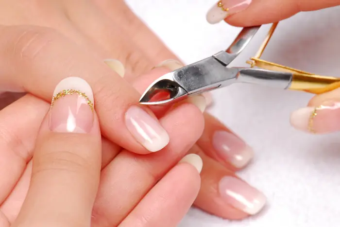 Picture of a hand manicuring a nail